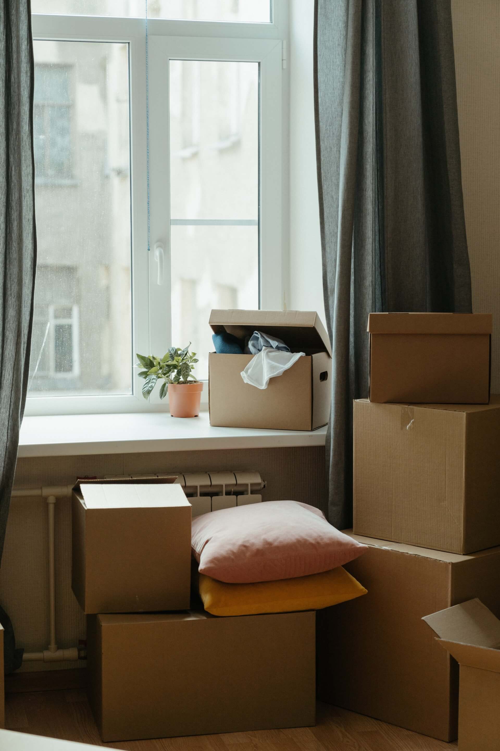 Packed removal cartons standing under the window